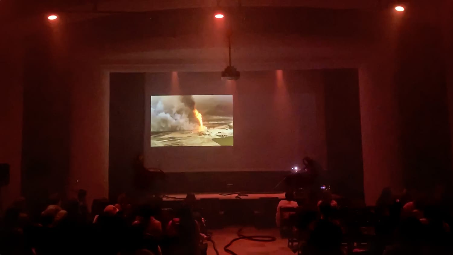 The expanded-cinema performance of At the Edge of the Sea in a darkened theatre