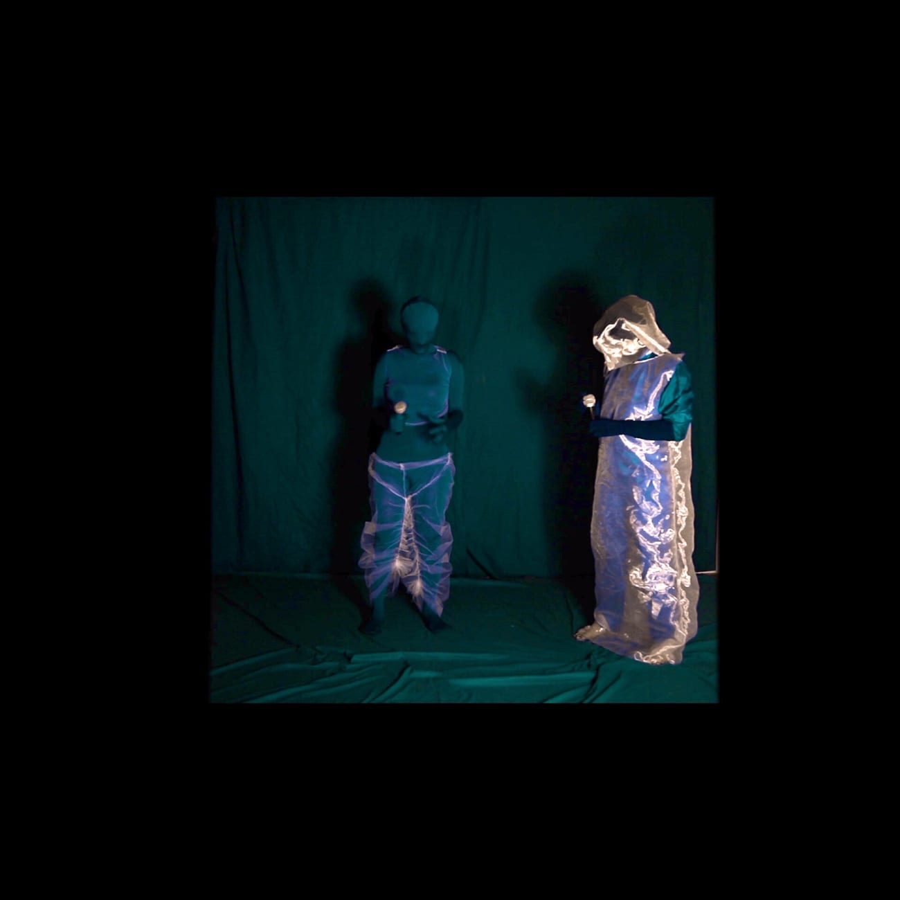 A figure in performance, bathed in blue, from At the Edge of the Sea